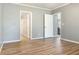 Neutral bedroom showcases wood flooring and easy access to the bathroom and kitchen at 11136 Grapefruit Ln, Punta Gorda, FL 33955