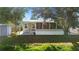Charming home exterior with a screened-in porch and covered walkway, providing comfortable outdoor space at 11136 Grapefruit Ln, Punta Gorda, FL 33955