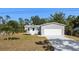 Charming single-Gathering home featuring a spacious front yard and a two-car garage at 11136 Grapefruit Ln, Punta Gorda, FL 33955