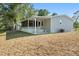This home features a screened in porch, a patio, and verdant landscaping that enhances curb appeal at 11136 Grapefruit Ln, Punta Gorda, FL 33955