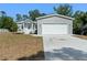 Charming single-Gathering home featuring a spacious front yard and a two-car garage at 11136 Grapefruit Ln, Punta Gorda, FL 33955