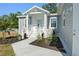 Inviting front porch with stylish landscaping, walkway, and white picket fence at 11136 Grapefruit Ln, Punta Gorda, FL 33955
