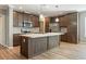 Modern kitchen featuring an island, stainless steel appliances, and wooden cabinets at 11136 Grapefruit Ln, Punta Gorda, FL 33955