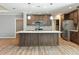 Modern kitchen featuring a large island, stainless steel appliances, and stylish pendant lighting at 11136 Grapefruit Ln, Punta Gorda, FL 33955