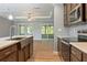 Bright kitchen with stainless steel appliances, a view into the breakfast nook, and a modern sink at 11136 Grapefruit Ln, Punta Gorda, FL 33955