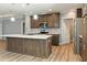 Modern kitchen featuring an island, stainless steel appliances, and wooden cabinets at 11136 Grapefruit Ln, Punta Gorda, FL 33955
