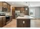 Modern kitchen featuring an island, stainless steel appliances, and wooden cabinets at 11136 Grapefruit Ln, Punta Gorda, FL 33955