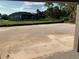 View of spacious backyard with room for a pool, and a beautiful screen enclosed porch in the background at 112 Cougar Way, Rotonda West, FL 33947
