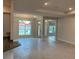 Bright and airy living room featuring large windows, tile flooring, and an open floor plan at 112 Cougar Way, Rotonda West, FL 33947