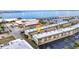 An aerial view showcases the waterfront condos, bridge, and nearby ocean at 150 Harborside Ave # 134, Punta Gorda, FL 33950