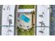 Aerial view of the condo complex's pool, and a small outdoor seating area with palm trees at 150 Harborside Ave # 134, Punta Gorda, FL 33950