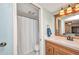 Bright bathroom with a shower stall and vanity featuring a framed mirror and ample lighting at 150 Harborside Ave # 134, Punta Gorda, FL 33950