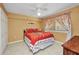 Cozy bedroom featuring tile flooring, a ceiling fan, and a cheerful, bright decor at 150 Harborside Ave # 134, Punta Gorda, FL 33950