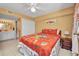 Comfortable bedroom with ample closet space, a ceiling fan, and a doorway to the ensuite bathroom at 150 Harborside Ave # 134, Punta Gorda, FL 33950