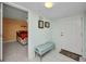 Inviting entryway with tiled floor, a bench, and views into the bedroom at 150 Harborside Ave # 134, Punta Gorda, FL 33950