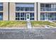 Exterior view of building featuring a lanai, well maintained lawn, and direct access to parking at 150 Harborside Ave # 134, Punta Gorda, FL 33950
