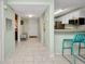 Spacious foyer with tile flooring, hall closet, and kitchen bar at 150 Harborside Ave # 134, Punta Gorda, FL 33950