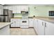 Well-equipped kitchen with stainless steel refrigerator and white appliances, offering functionality and style at 150 Harborside Ave # 134, Punta Gorda, FL 33950