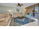 Inviting living room with tile floors, light-colored sofas, and a sliding glass door at 150 Harborside Ave # 134, Punta Gorda, FL 33950