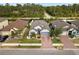 Charming single-Gathering home boasts a well-manicured lawn, brick driveway, and mature landscaping at 15193 Mille Fiore Blvd, Port Charlotte, FL 33953