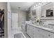 Bright bathroom with double vanity, granite countertops, and a walk-in closet at 15193 Mille Fiore Blvd, Port Charlotte, FL 33953