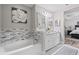 Bright bathroom with double sink vanity, tub, and modern finishes at 15193 Mille Fiore Blvd, Port Charlotte, FL 33953