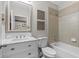Well-lit bathroom featuring a vanity with drawers, framed mirror, and a shower over a tub at 15193 Mille Fiore Blvd, Port Charlotte, FL 33953