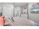 Bedroom featuring a large bed, dresser with mirror, closet and decor at 15193 Mille Fiore Blvd, Port Charlotte, FL 33953