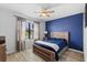 Bedroom featuring stylish ceiling fan, wooden bedframe, and neutral wood laminate floor at 15193 Mille Fiore Blvd, Port Charlotte, FL 33953
