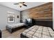Bedroom with two beds, wood accent wall, ceiling fan and window with blinds at 15193 Mille Fiore Blvd, Port Charlotte, FL 33953