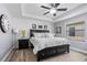 Bright bedroom with king bed, tray ceiling, ceiling fan, and large window at 15193 Mille Fiore Blvd, Port Charlotte, FL 33953