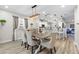 Dining room area with stylish light fixture, adjacent to a modern kitchen and living area at 15193 Mille Fiore Blvd, Port Charlotte, FL 33953