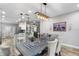 Open concept dining room with modern light fixture, with view of the kitchen and living space at 15193 Mille Fiore Blvd, Port Charlotte, FL 33953
