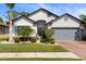 Charming single-Gathering home boasts a well-manicured lawn, brick driveway, and mature landscaping at 15193 Mille Fiore Blvd, Port Charlotte, FL 33953