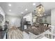 Open kitchen view with granite countertops, stainless appliances, and stylish pendant lighting at 15193 Mille Fiore Blvd, Port Charlotte, FL 33953