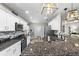 Bright kitchen with granite counters, stainless appliances, and bar seating at 15193 Mille Fiore Blvd, Port Charlotte, FL 33953