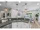 Bright kitchen with pendant lighting and stainless steel sink and faucet at 15193 Mille Fiore Blvd, Port Charlotte, FL 33953