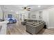 Spacious living room featuring modern ceiling fan, and stylish gray sectional at 15193 Mille Fiore Blvd, Port Charlotte, FL 33953