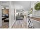 Bright living room featuring modern flooring, and an open layout with views into other living spaces at 15193 Mille Fiore Blvd, Port Charlotte, FL 33953