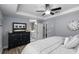 Large bedroom features a king bed, tray ceiling, and ensuite bath at 15193 Mille Fiore Blvd, Port Charlotte, FL 33953