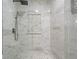 This bathroom features a stunning tile shower with a rain shower head and beautiful marble accents at 15193 Mille Fiore Blvd, Port Charlotte, FL 33953