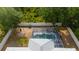 Aerial view featuring a pool and fenced yard surrounded by lush greenery at 1773 Portage St, North Port, FL 34287