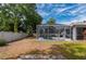 Backyard with a screened in pool, vinyl fence and minimal foliage at 1773 Portage St, North Port, FL 34287
