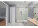 This bathroom features a walk in shower with glass door, and a vanity with white cabinets at 1773 Portage St, North Port, FL 34287