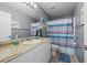 This bathroom features a vanity with white cabinets and a shower/tub combo at 1773 Portage St, North Port, FL 34287