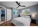 Bedroom with hard wood floors, ceiling fan, and a view into the next room through an open door at 1773 Portage St, North Port, FL 34287