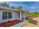 Close-up view of the home's entrance, showcasing decorative landscaping and architectural details at 1773 Portage St, North Port, FL 34287