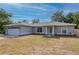 Charming single-story home showcasing a well-maintained lawn, a two-car garage, and welcoming front entrance at 1773 Portage St, North Port, FL 34287