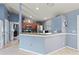 Open-concept kitchen area with tile flooring, wood cabinetry, stainless steel appliances, and ample counter space at 1773 Portage St, North Port, FL 34287