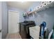 This laundry room has modern appliances, a utility sink, and shelving at 1773 Portage St, North Port, FL 34287